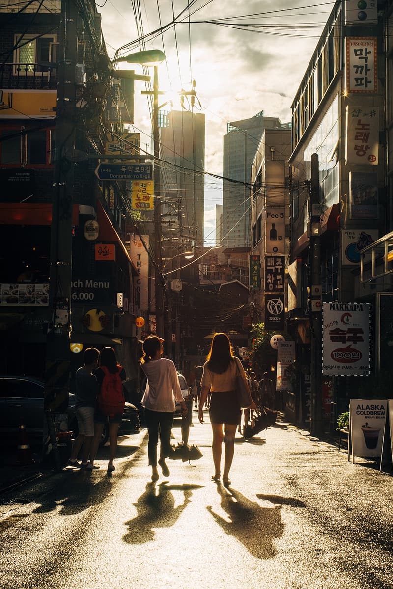 People walking along a sunlit city street